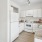 a kitchen with white cabinets