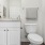 a bathroom with white cabinets